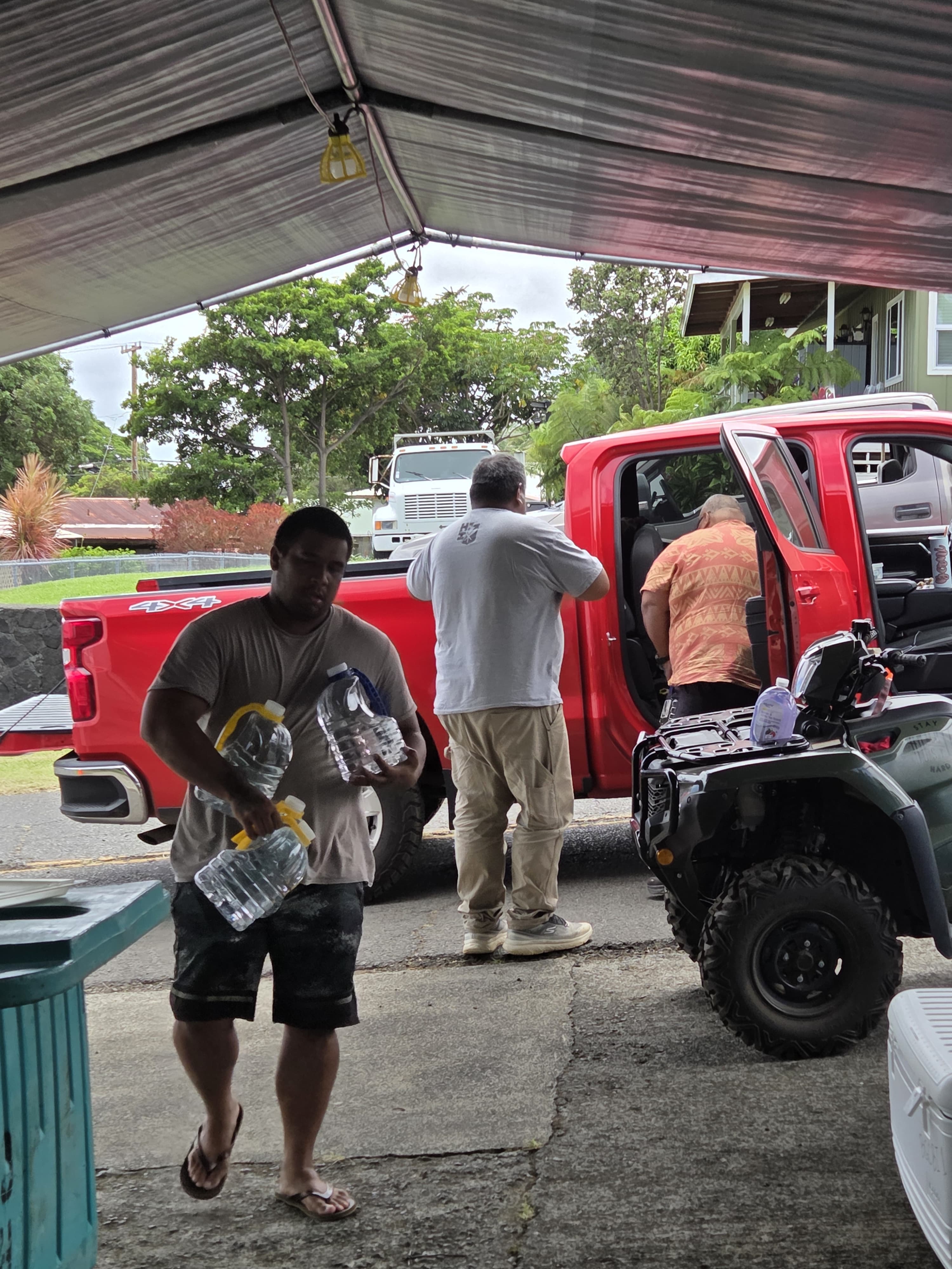 Donated drinking water being carried from the truck to the relief hub