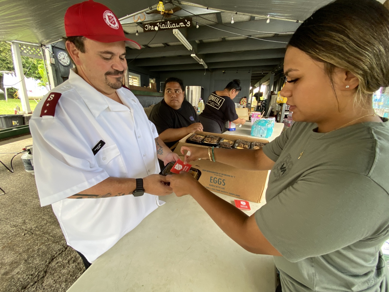 Captain Sam LeMar of The Salvation Army working with Kaumahana Hub volunteers to prepare delivered meals