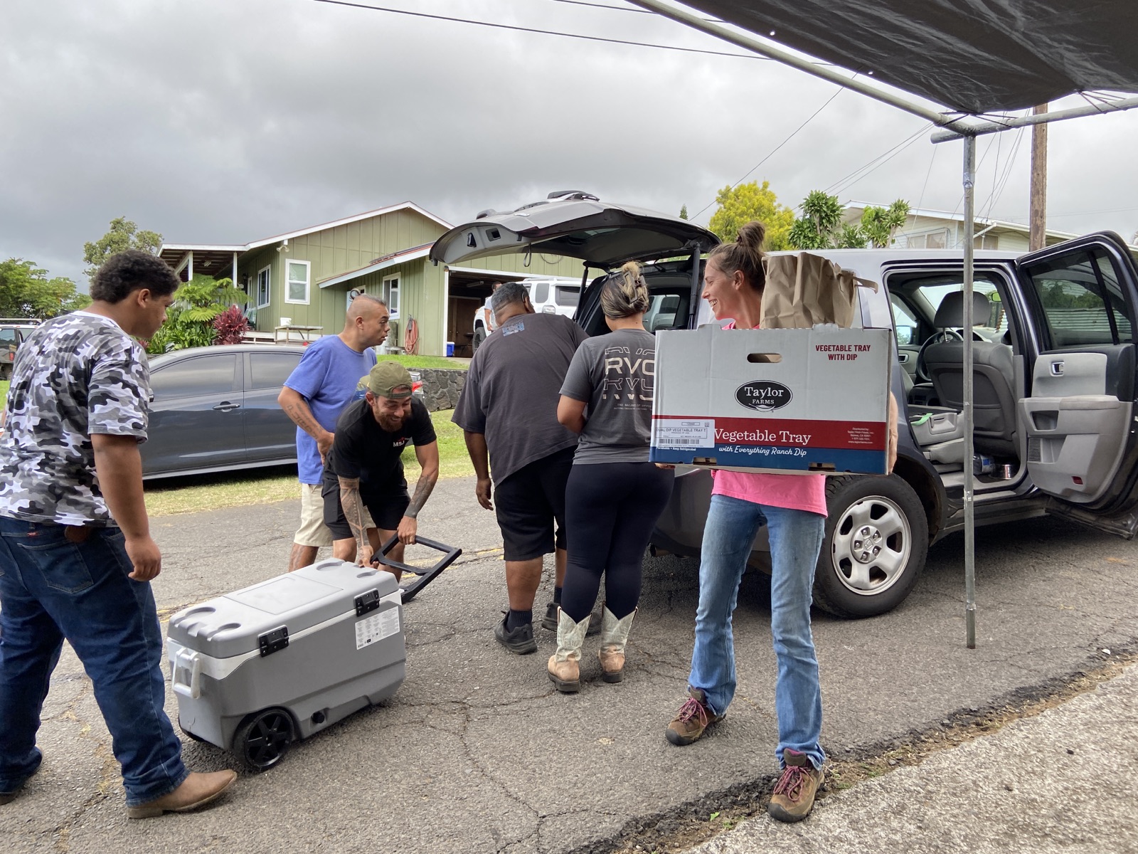 Volunteers unload a Salvation Army food delivery at Kaumahana Hub