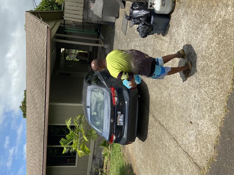 A volunteer delivers drinking water