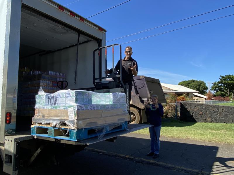 Volunteers unload donated beverages and water